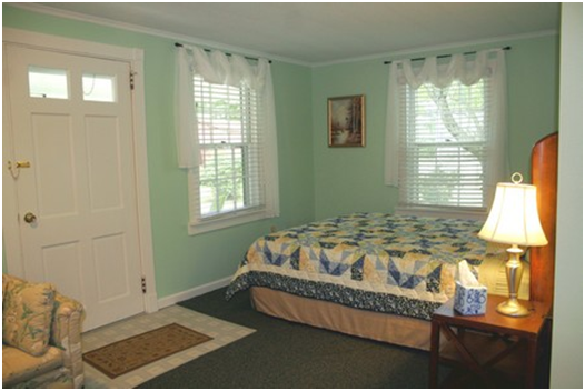 The second sleeping area also includes a queen bed and a nightstand.  There is a large curtain separating the sitting and sleeping areas that can be drawn for privacy.  A chest and small closet is located in the hallway for extra storage of personal items.  Bed linens are included for both sleeping areas.